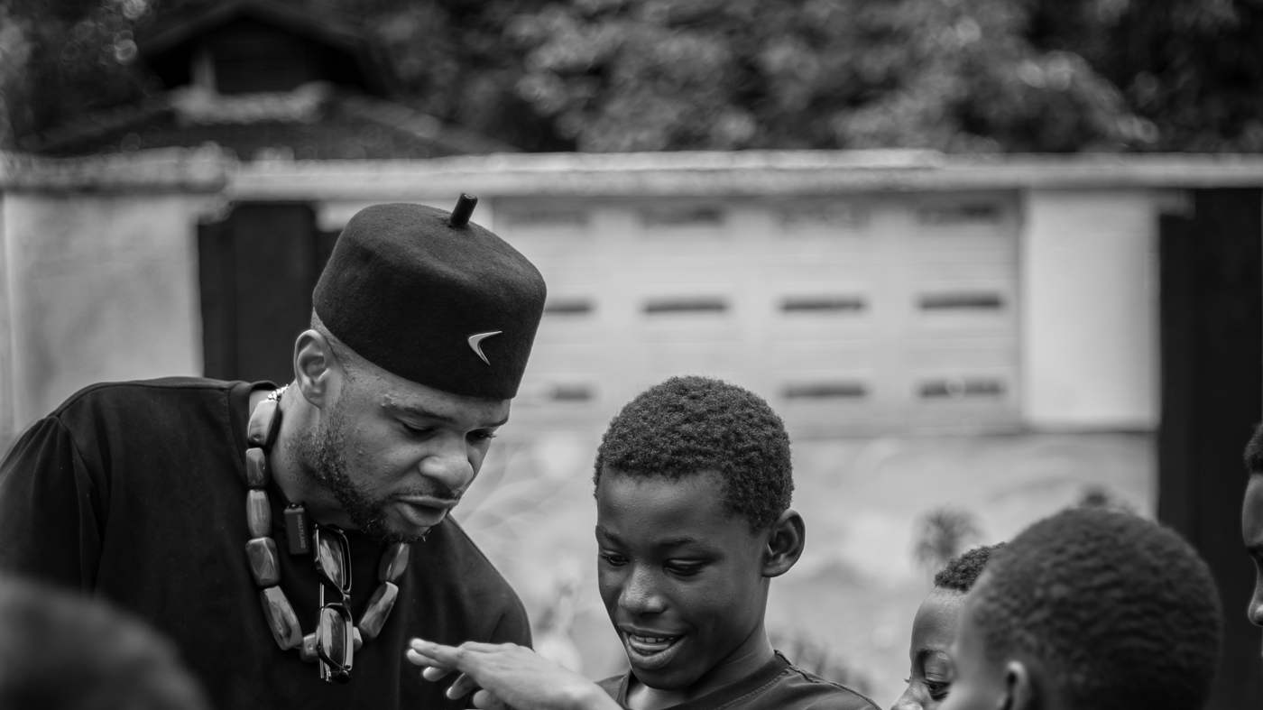 B. Amechi with children in Uganda